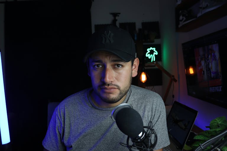 Male content creator in a home studio setup with microphone and soft lighting to increase IG Followers