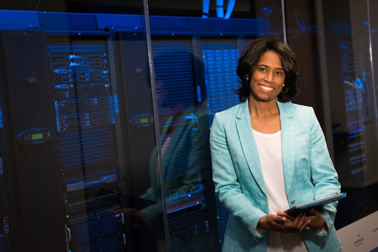Smiling woman in data center showcasing Monetize Kongotech .
