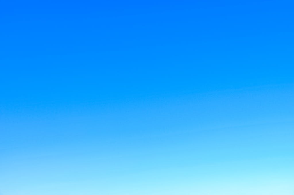 Newtopy A serene view of a vibrant clear blue sky with a subtle gradient, perfect for backgrounds.