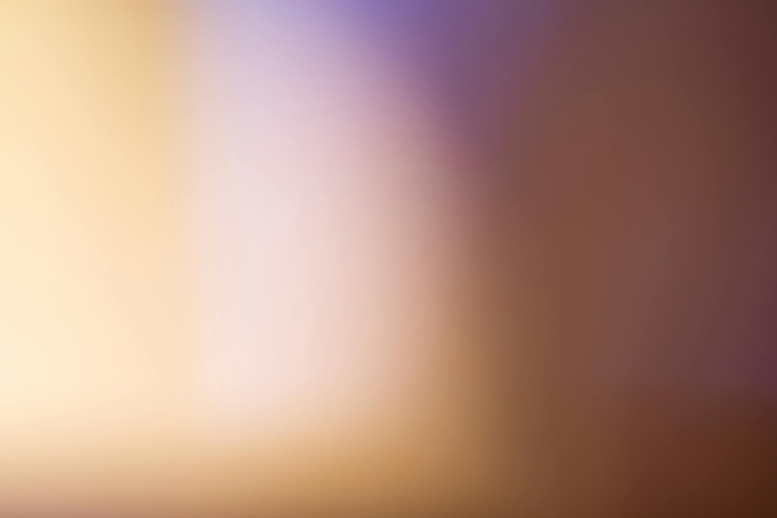 Newtopy A soothing abstract blurred gradient background with warm tones.