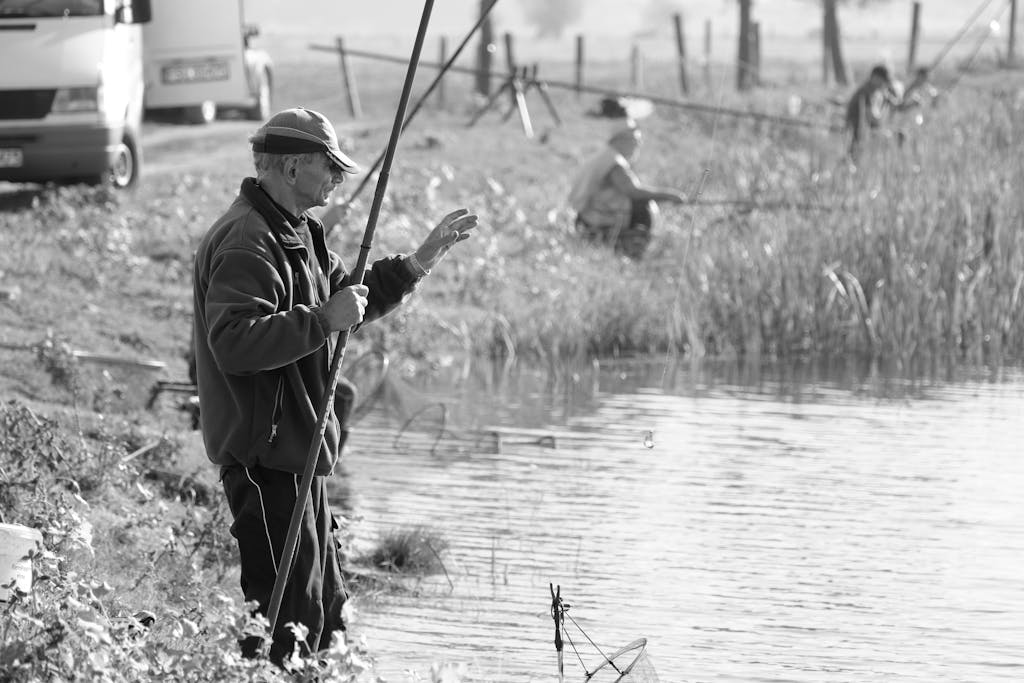 Texas Hunting Forum Black and white image of men fishing by a peaceful riverside setting.