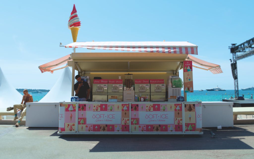Messeregge Charming ice cream stall on the sunny beachside in Cannes, offering a delightful summer experience.