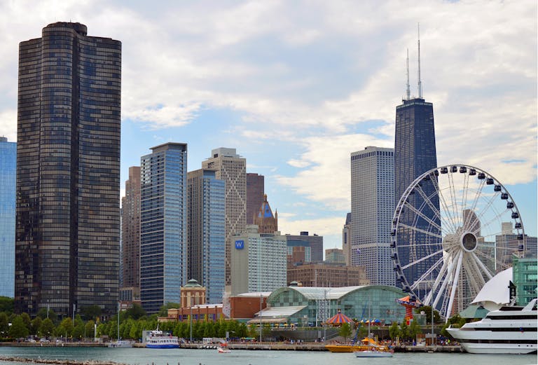 Chicago Cubs Chicago skyline featuring the iconic Ferris wheel on Navy Pier with skyscrapers like Hancock Tower.