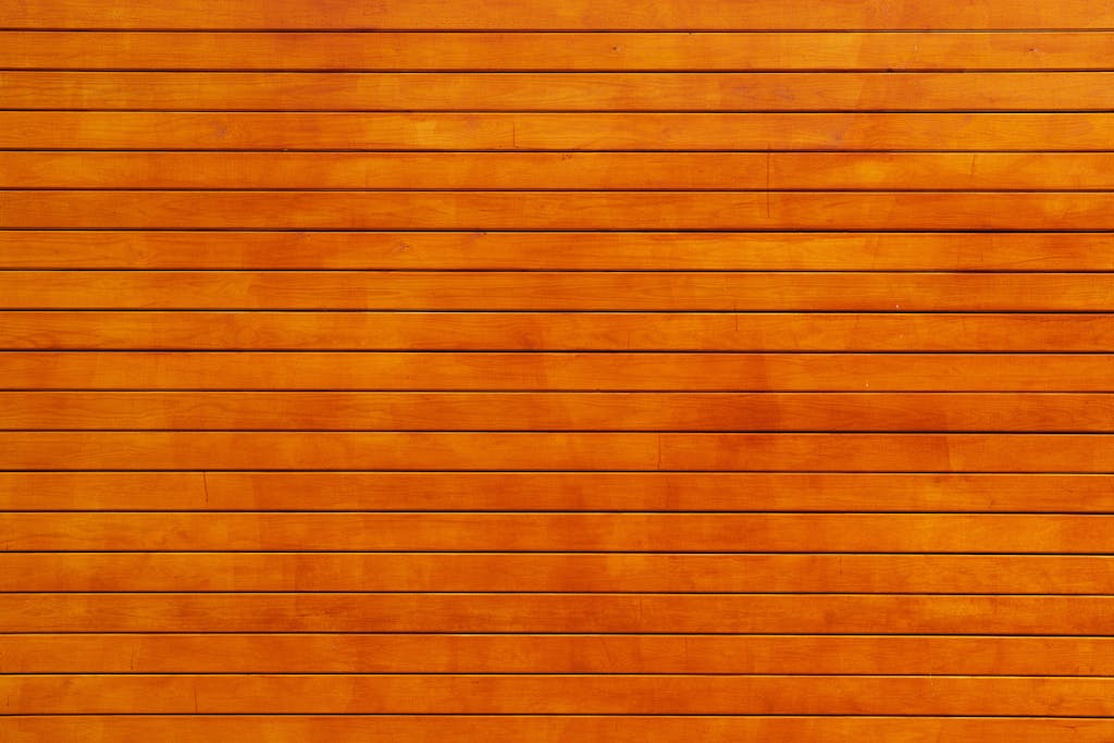 Voozon Close-up of a vibrant orange wooden wall texture, ideal for backgrounds.