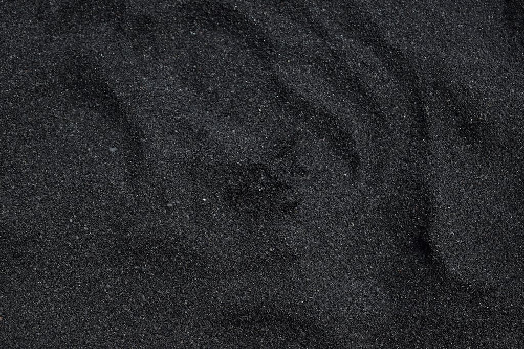 Emfyteymata  Close-up of black sand texture from Waimea Beach in Hawaii. Ideal for backgrounds.