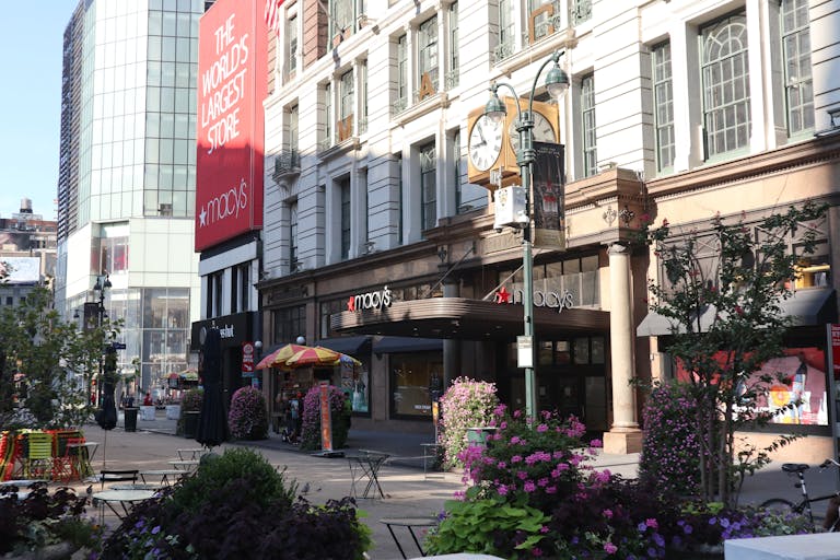 New York Jets Daytime view of Macy's storefront in New York City, showcasing urban architecture and bustling streets.