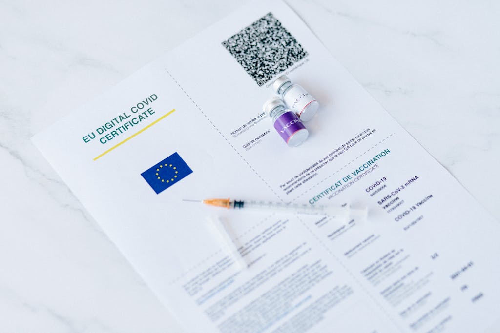 Six Sigma Certification Online EU digital COVID certificate with vaccine vials and syringe on a white background.
