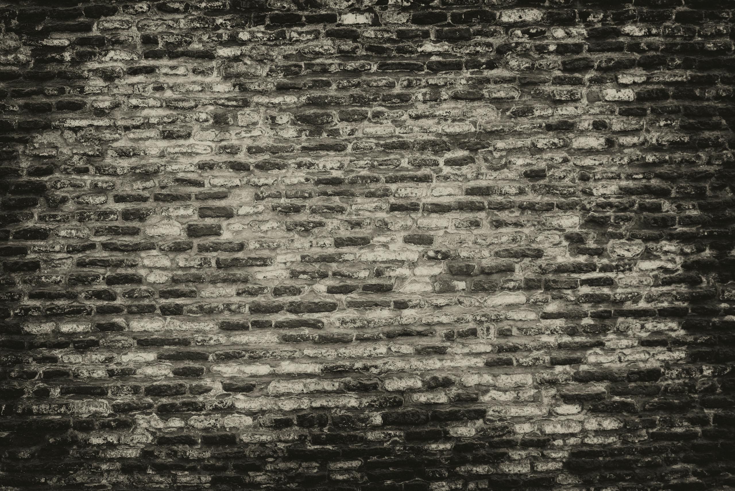 MMSBRE Grayscale textured brick wall background with rough surface.