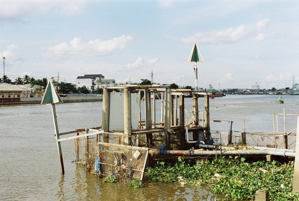 vRealize Infrastructure Navigator Urban waterway scene with unique structures and distant skyline under a bright sky.