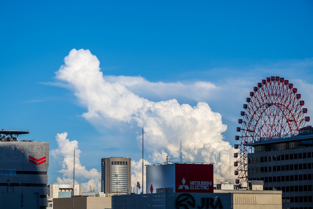 Shop Sunnylife Giant Jumbling Tower Vibrant urban skyline featuring towering buildings and a ferris wheel under a striking cloud formation.